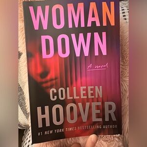 Woman down paerback book by Colleen Hoover